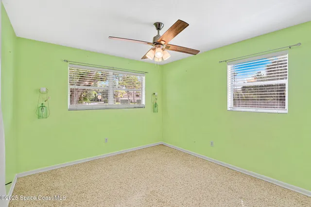 a living room with glass door and an outdoor view