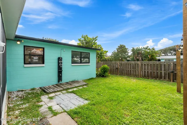 a view of a house with a yard porch and sitting area