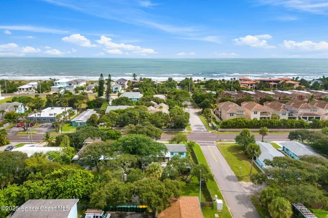 an aerial view of residential houses with outdoor space