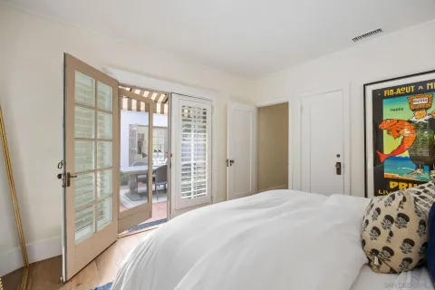 a bedroom with a large bed and a window