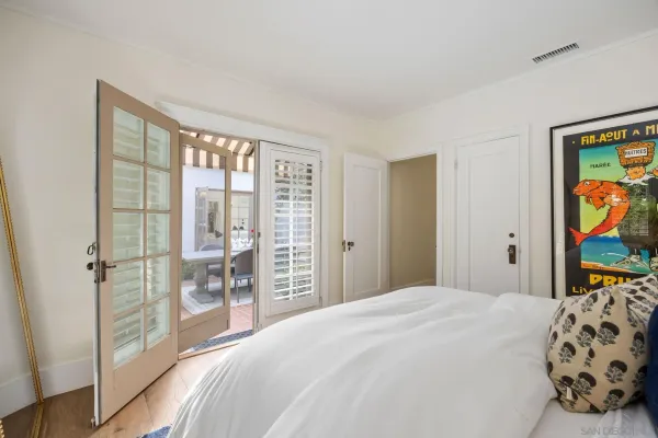 a bedroom with a large bed and a window