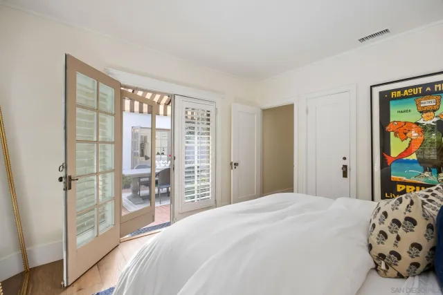 a bedroom with a large bed and a window