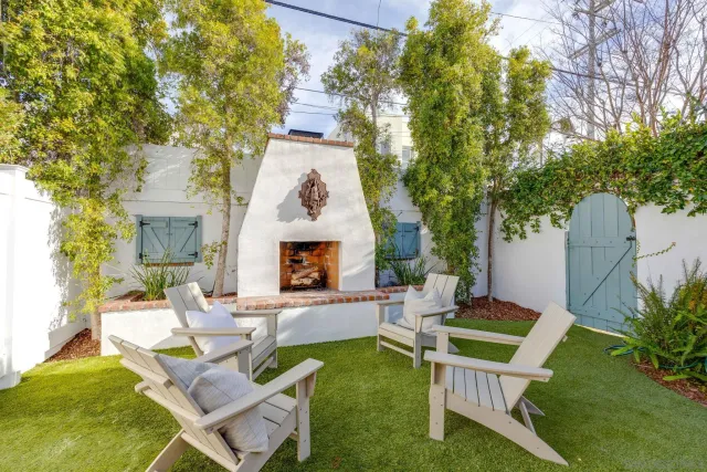 a view of a house with backyard sitting area and garden