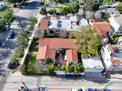 an aerial view of a house with garden space and street view