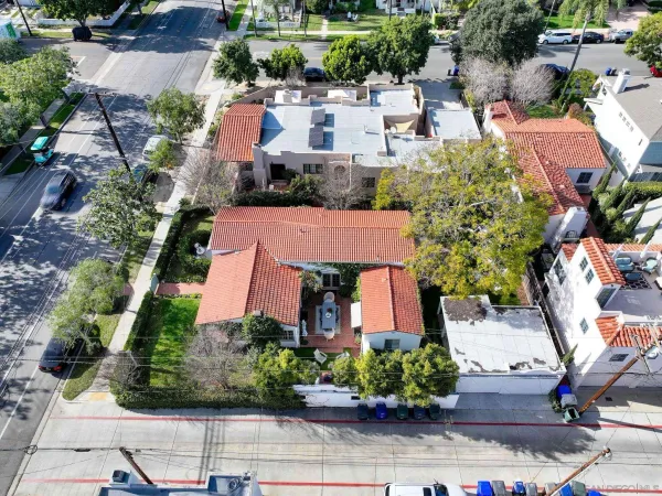 an aerial view of a house with garden space and street view