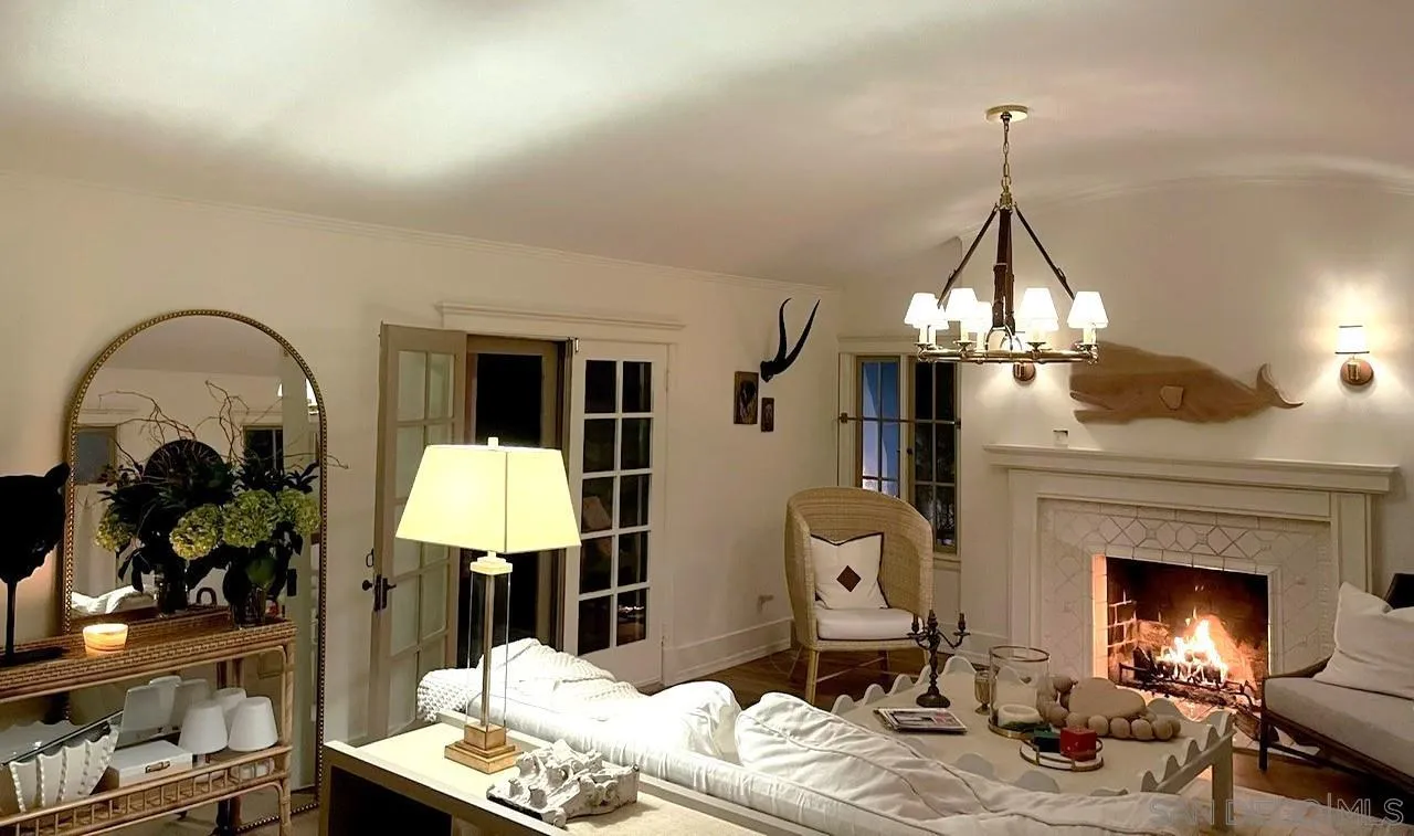 811 10th Street Coronado, CA 92118 - Photo 5 of 7 a living room with furniture chandelier and a fireplace