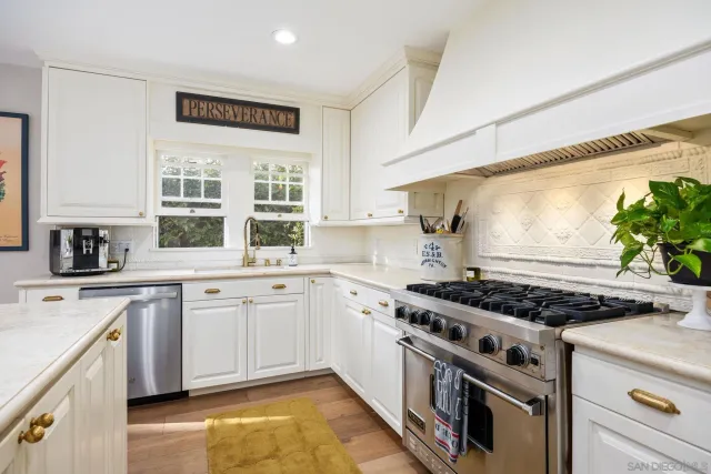 a kitchen with stainless steel appliances granite countertop a stove and a sink