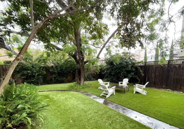 a view of a chair and table in the garden