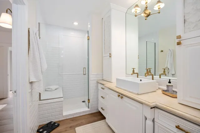 a bathroom with a shower sink and mirror
