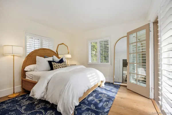 a bedroom with a bed and a large window