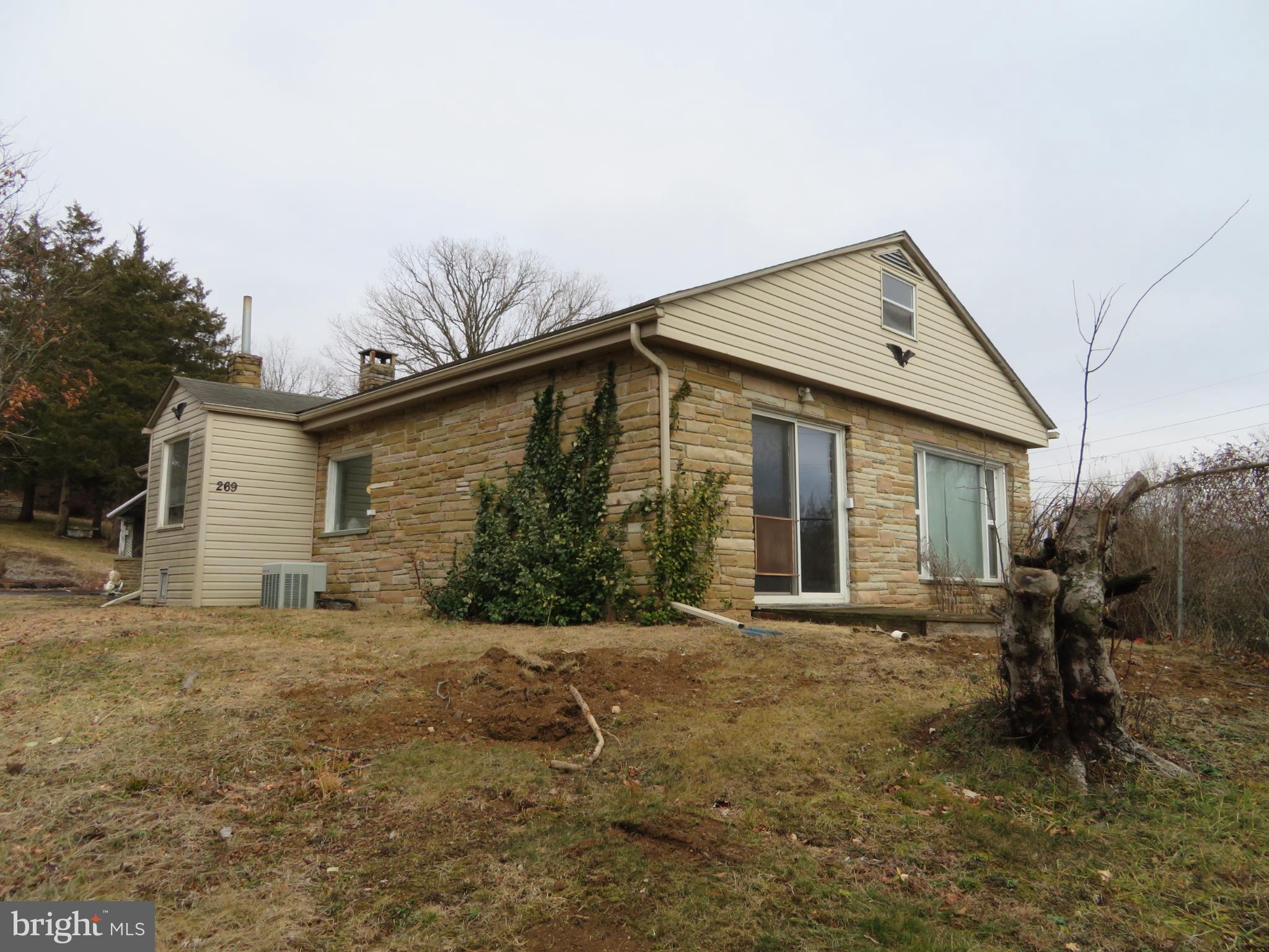 269 Crawford Quarry Road Falling Waters, WV 25419 - Photo 2 of 19 a front view of house with yard and trees in the background