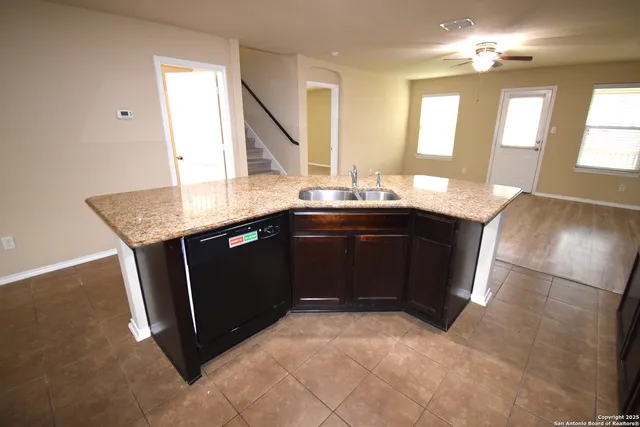 a kitchen with a sink a stove and cabinets