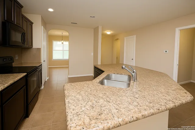 a bathroom with a granite countertop sink a toilet and mirror