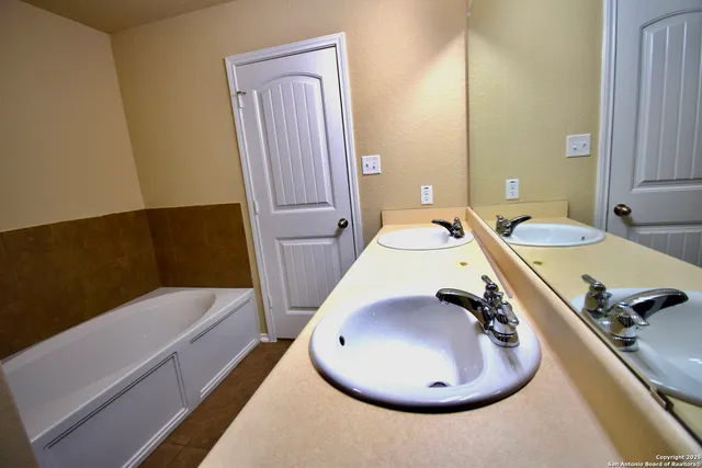 a bathroom with a tub and a mirror