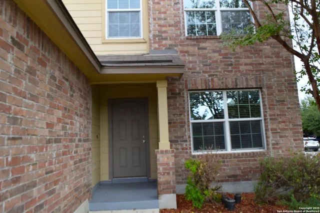a front view of a house with large windows