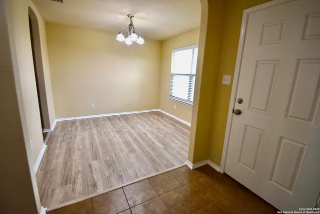 wooden floor in an empty room with a mirror