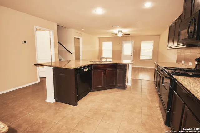 a view of kitchen with cabinets counter top space and stainless steel appliances
