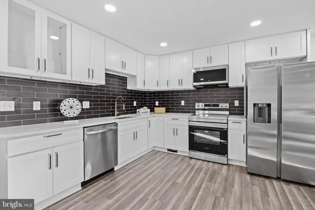 a kitchen with a refrigerator stove and microwave