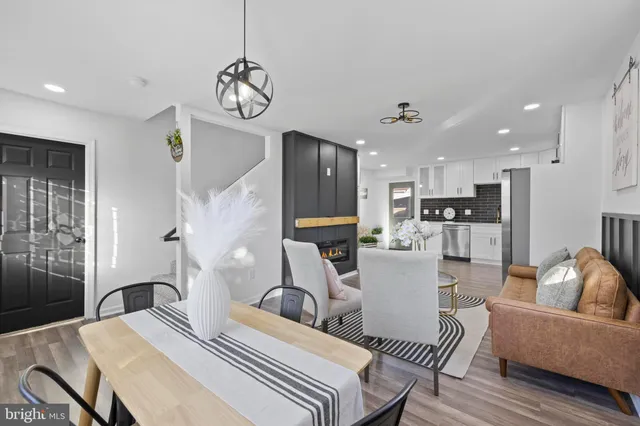 a bedroom with a large bed and wooden floor