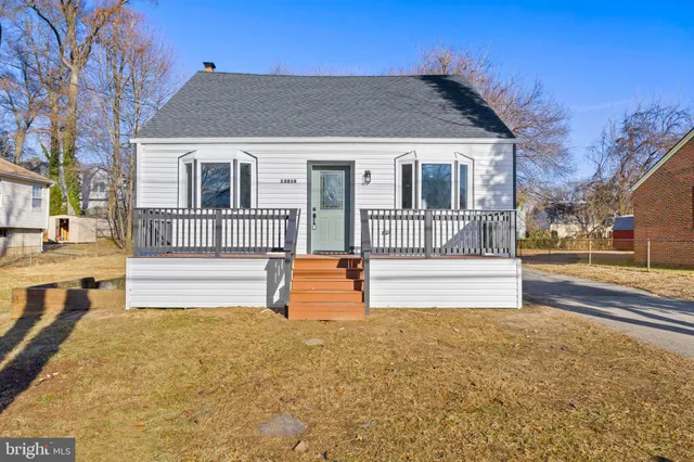 a view of a house with swimming pool and sitting area