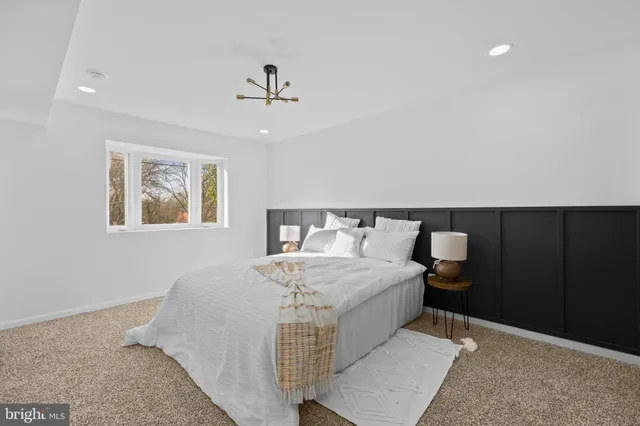 a bathroom with a granite countertop sink a toilet and shower