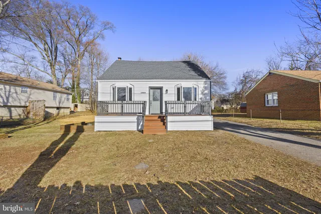 a view of a house with a large tree in front of it