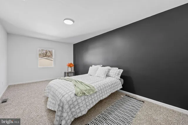 a bedroom with a bed and a table in it