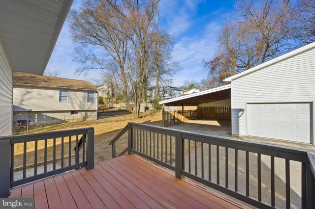 a view of a house with a yard and wooden fence