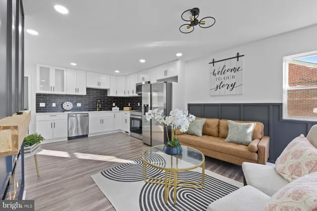 a living room with furniture and kitchen view