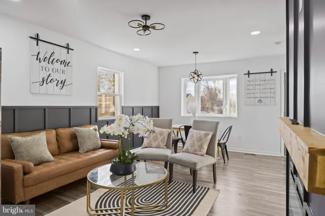 a living room with furniture and a chandelier