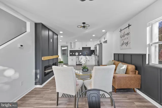 a dining room with furniture and wooden floor