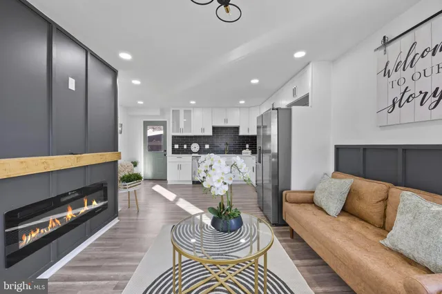 a living room with furniture and a fireplace