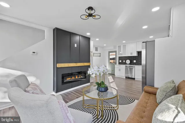 a living room with furniture fireplace and dining table