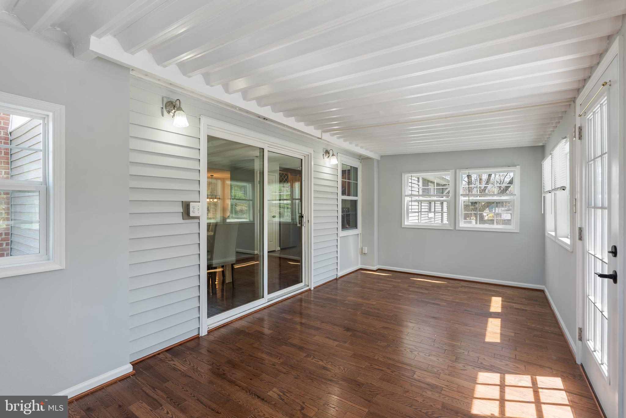 10021 Fox Den Road Ellicott City, MD 21042 - Photo 13 of 41 a view of an empty room with wooden floor and a window