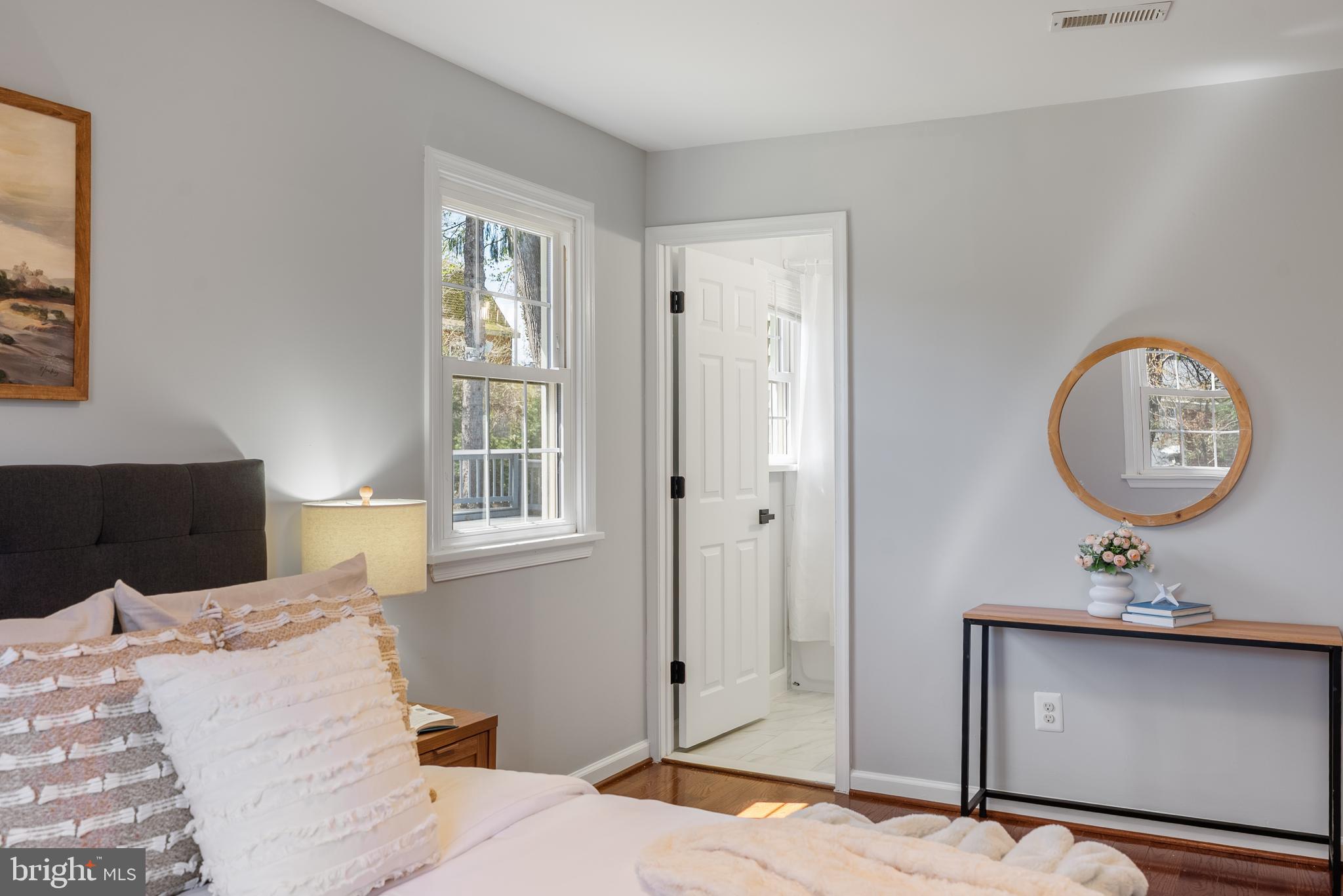 10021 Fox Den Road Ellicott City, MD 21042 - Photo 17 of 41 a bedroom with a bed a mirror and a window