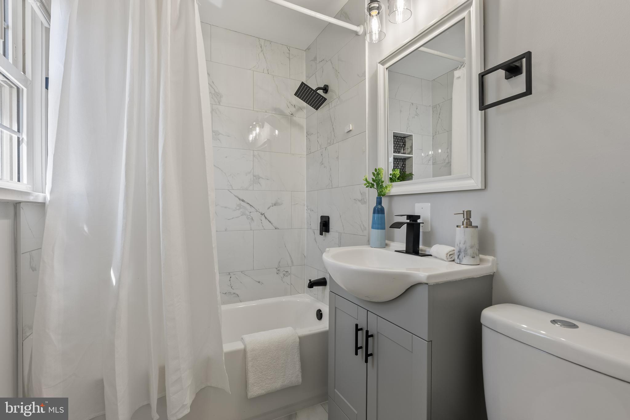 10021 Fox Den Road Ellicott City, MD 21042 - Photo 18 of 41 a bathroom with a sink a toilet a tub and shower