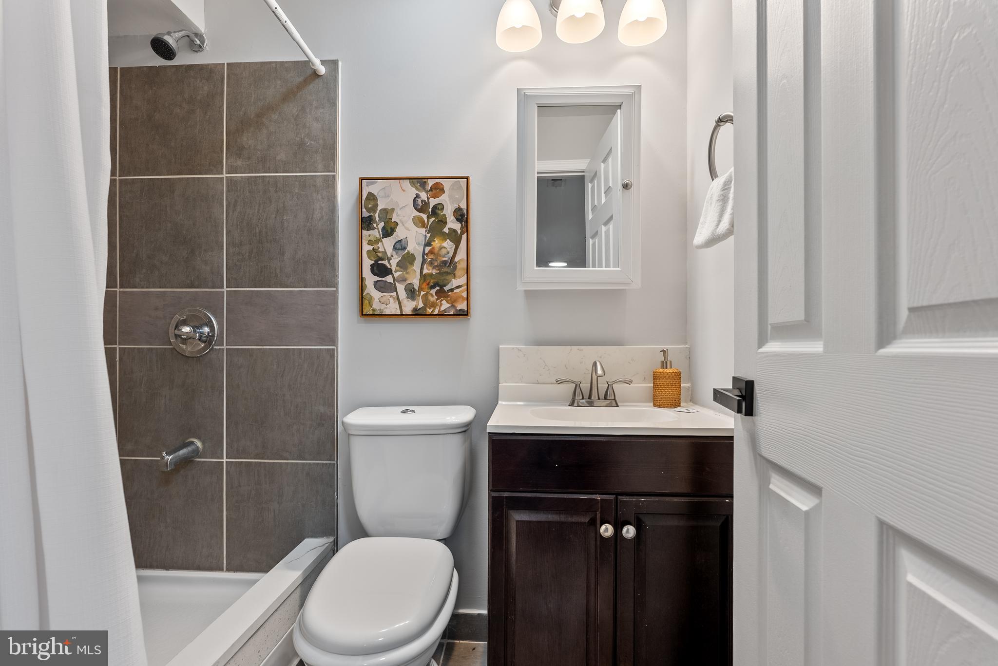 10021 Fox Den Road Ellicott City, MD 21042 - Photo 27 of 41 a bathroom with a toilet a sink and mirror