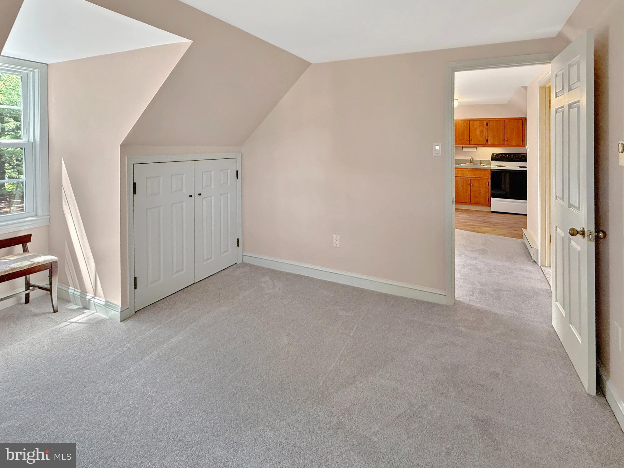 1609 Walton Road Blue Bell, PA 19422 - Photo 41 of 64 an empty room with kitchen view and wooden floor