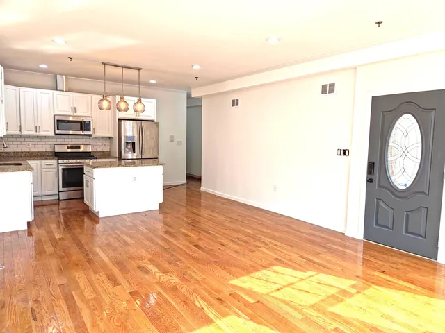 a kitchen with stainless steel appliances a stove sink and microwave