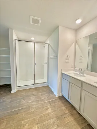 a bathroom with a double vanity sink a mirror and a shower