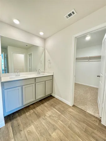 a bathroom with a sink double vanity and a mirror