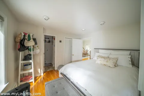 a bedroom with a bed and a walk in closet
