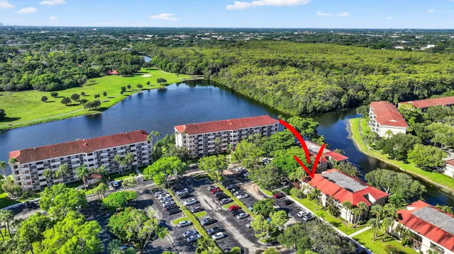 an aerial view of a house with a swimming pool a yard and lake view