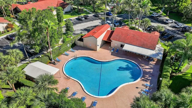 an aerial view of a house with a swimming pool and outdoor seating