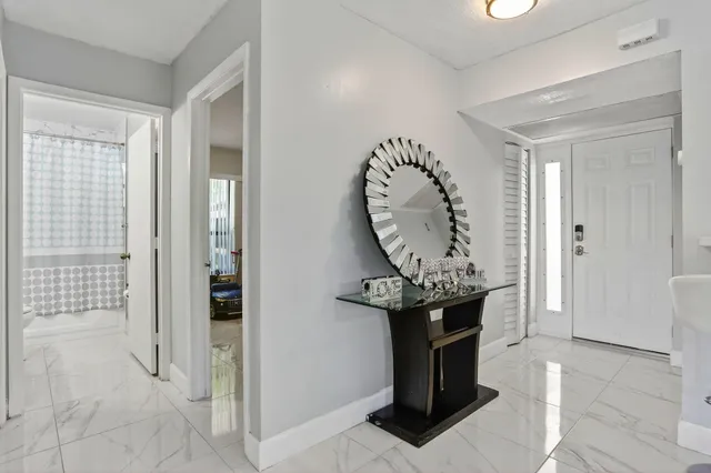 a kitchen with stainless steel appliances kitchen island granite countertop a refrigerator and a stove top oven