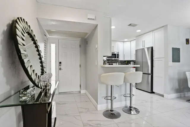 a living room with furniture a chandelier and a window
