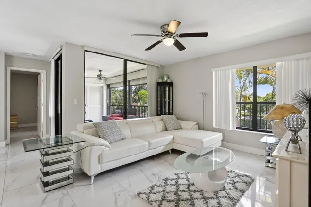 a living room with furniture and a view of kitchen