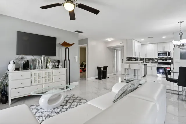 a kitchen with stainless steel appliances granite countertop a refrigerator sink and stove