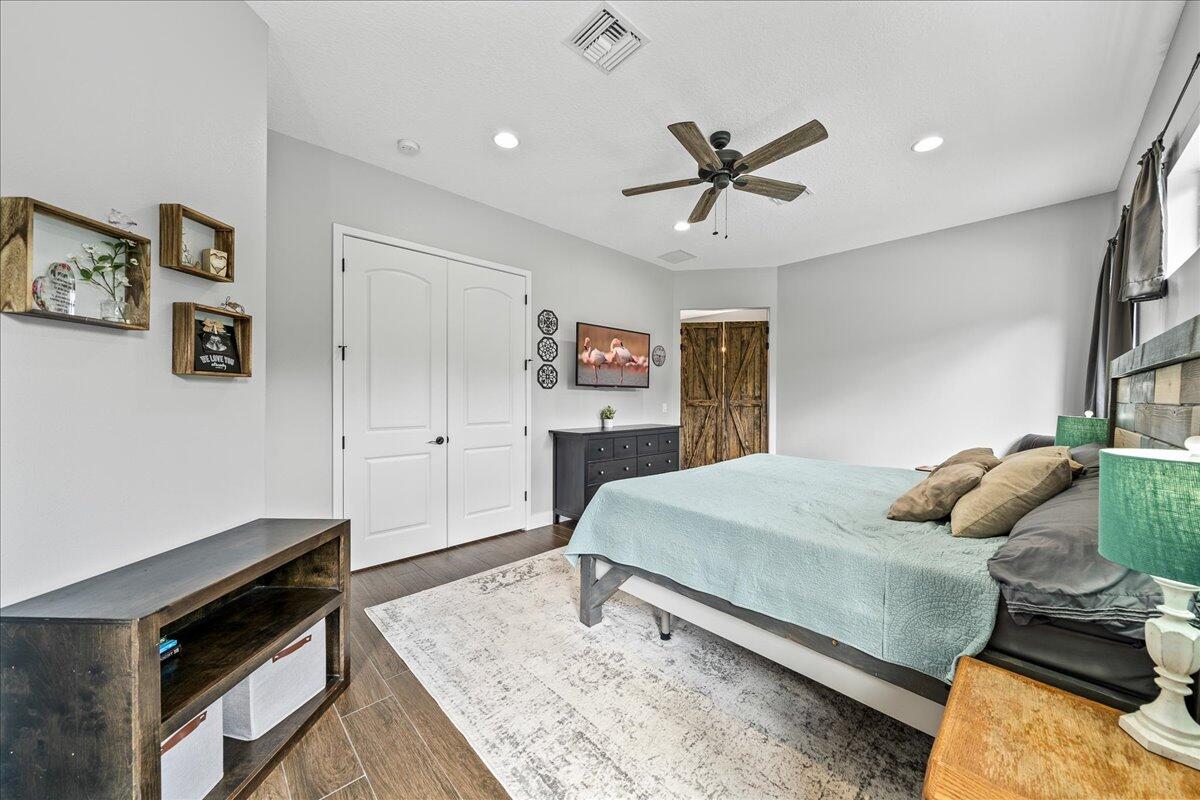 3490 Grant Line Road Mims, FL 32754 - Photo 13 of 43 a bedroom with a bed and a dresser