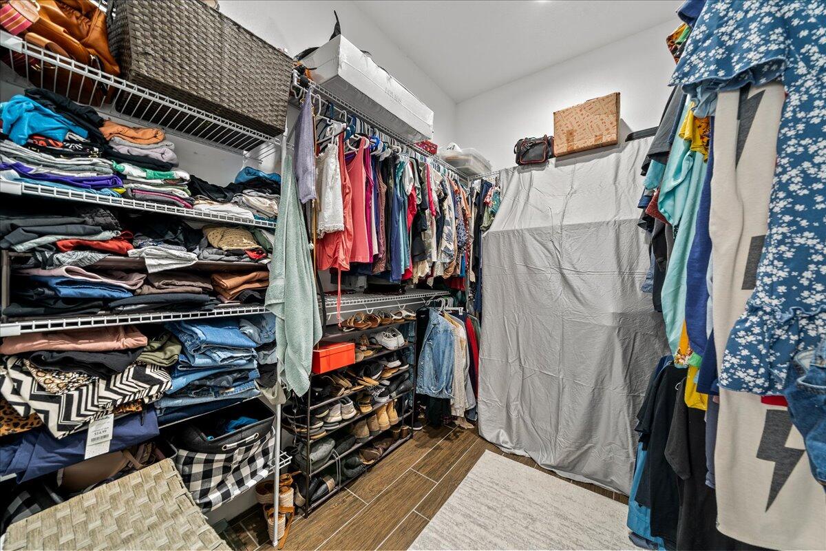 3490 Grant Line Road Mims, FL 32754 - Photo 16 of 43 a view of walk in closet with clothes and shoes